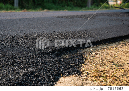 New asphalt tarmac texture road of repairing on the damaged highway New asphalt tarmac texture road of repairing on the damaged highway 76176624