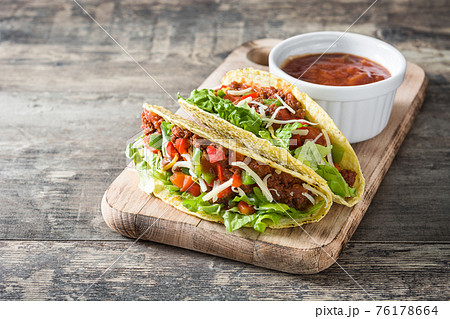 Traditional Mexican tacos with meat and vegetables on wood 76178664