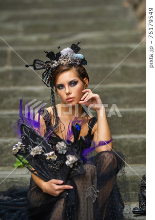 Beautiful stylish bride in a black dress sits on the stairs in Florence, Italy Beautiful stylish bride in a black dress sits on the stairs in Florence, Italy 76179549
