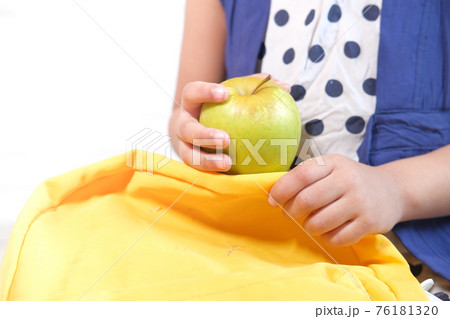 child hand holding green apple on white background child hand holding green apple on white background 76181320