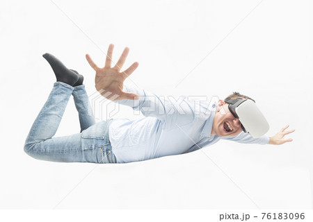 Man in virtual reality glasses hovers or flies. VR games concept. Man in virtual reality glasses hovers or flies. VR games concept. 76183096