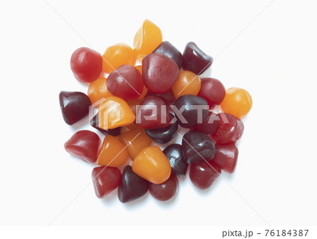 Close-up texture of red, orange and purple multivitamin gummies on white background. Healthy lifestyle concept. 76184387