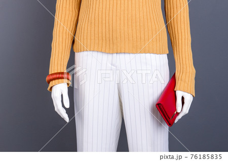 Female mannequin with red bracelet and wallet. Female mannequin with red bracelet and wallet. 76185835