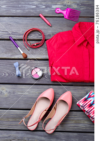 Various makeup products, shirt and shoes. 76186384