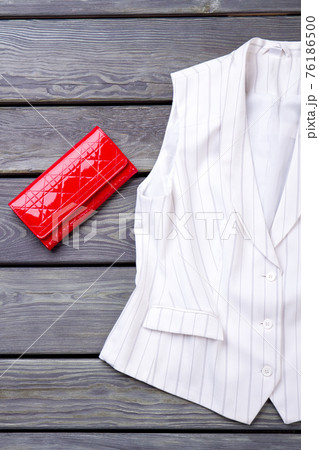 Red wallet and white sleeveless jacket. Red wallet and white sleeveless jacket. 76186500