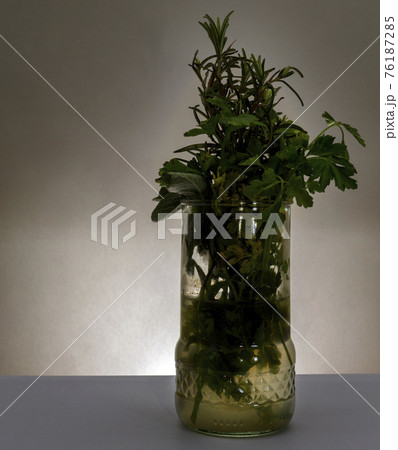Glass with aromatic herbs Glass with aromatic herbs 76187285