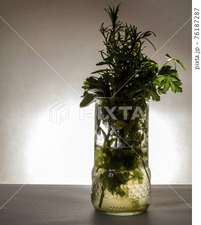 Glass with aromatic herbs 76187287