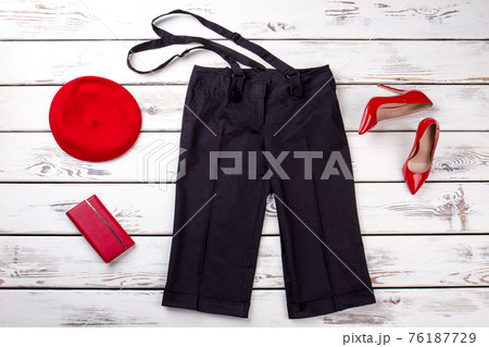 Black trousers with suspenders and red accessories. Black trousers with suspenders and red accessories. 76187729