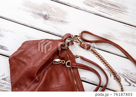 Close up brown leather satchel. Close up brown leather satchel. 76187803