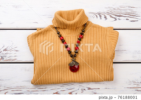 Yellow winter sweater with red stone necklace. Yellow winter sweater with red stone necklace. 76188001