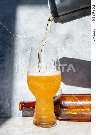 Serving beer in a crystal glass for IPA Serving beer in a crystal glass for IPA 76189352