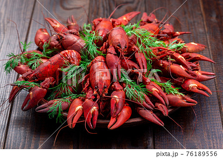 Crayfishes on ceramic plate served with dill, dark wooden background, horizontal 76189556