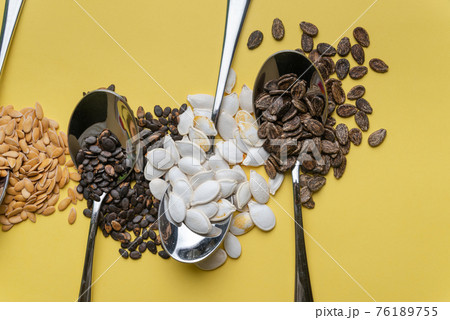 Watermelon, pumpkin and melon seeds on a yellow background 76189755