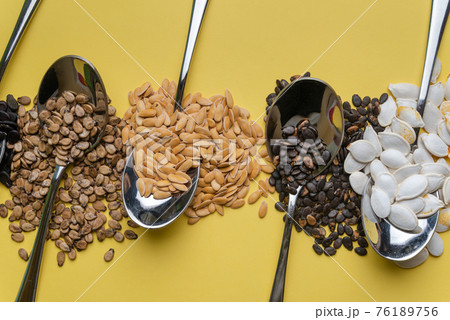 Watermelon, pumpkin and melon seeds on a yellow background 76189756