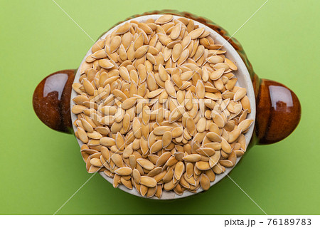 Melon seeds. Melon seeds on a green background Melon seeds. Melon seeds on a green background 76189783