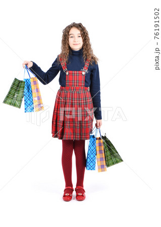 Child with a packaging checkered texture isolated on white background. Girl likes shopping on sale season. Holiday present, shopping. 76191502