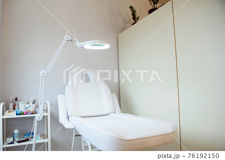 Interior of a cosmetology office.Modern equipment of cosmetology.White chair for cosmetology 76192150