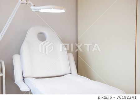 Interior of a cosmetology office.Modern equipment of cosmetology.White chair for cosmetology Interior of a cosmetology office.Modern equipment of cosmetology.White chair for cosmetology 76192241