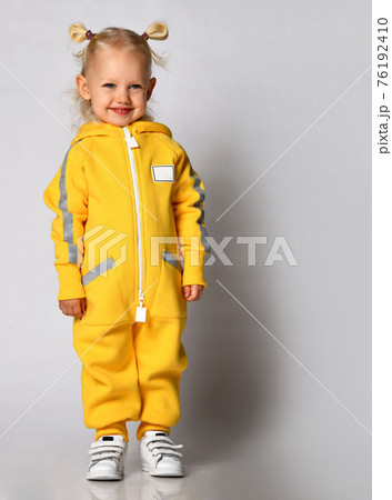 Little cute blonde girl in a warm comfortable 76192410