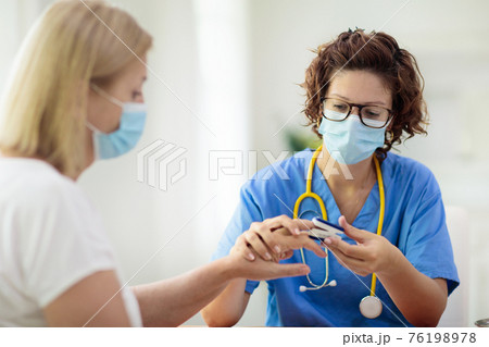 Doctor examining sick patient. Ill woman in clinic 76198978