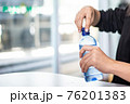 Woman opening bottle of water ,Don't forget to hydrate yourself 76201383