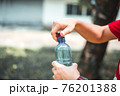 Man opening bottle of water 76201388