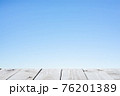 Wood plank table top on blue background 76201389