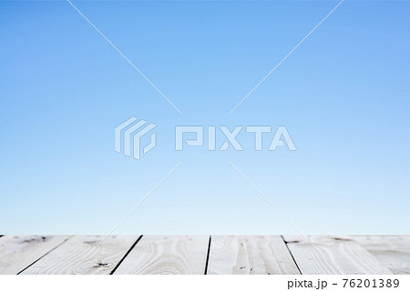 Wood plank table top on blue background 76201389