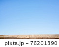 Wood plank table top on blue background 76201390