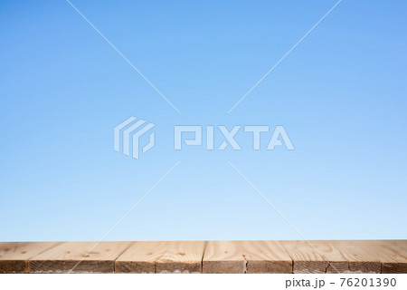 Wood plank table top on blue background 76201390