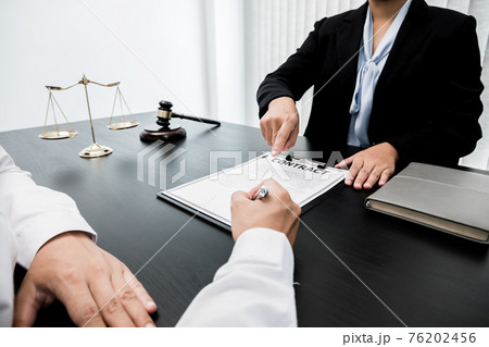 A woman lawyer or a judge counseling clients about judicial justice and prosecution with scales, judges gavel, legal documents legal services concept A woman lawyer or a judge counseling clients about judicial justice and prosecution with scales, judges gavel, legal documents legal services concept 76202456