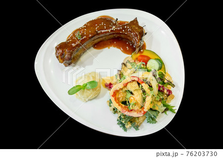 Barbecue Pork Spare Ribs with mix Cream salad vegetable on black background. Barbecue Pork Spare Ribs with mix Cream salad vegetable on black background. 76203730