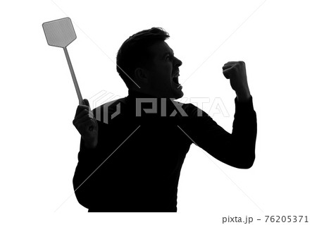 Silhouette of furious man trying to kill mosquito with fly swatter. Silhouette of furious man trying to kill mosquito with fly swatter. 76205371