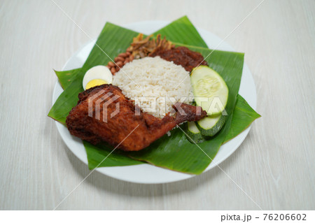Nasi Lemak dish with chicken drum stick on white wooden verneer 76206602