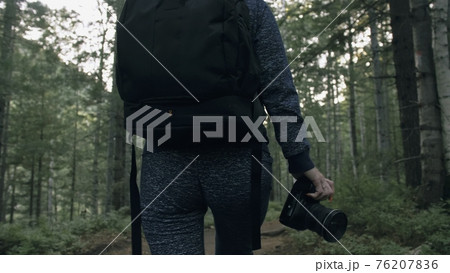 Traveler photographing scenic view in forest. One caucasian woman shooting close up look. Girl hold dslr mirrorless camera in his hand. Outdoor. Traveler photographing scenic view in forest. One caucasian woman shooting close up look. Girl hold dslr mirrorless camera in his hand. Outdoor. 76207836