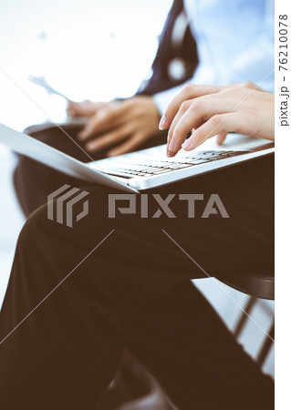 Group of business people working in office, close-up. Businesswoman typing on laptop. Conference, training or meeting concepts Group of business people working in office, close-up. Businesswoman typing on laptop. Conference, training or meeting concepts 76210078