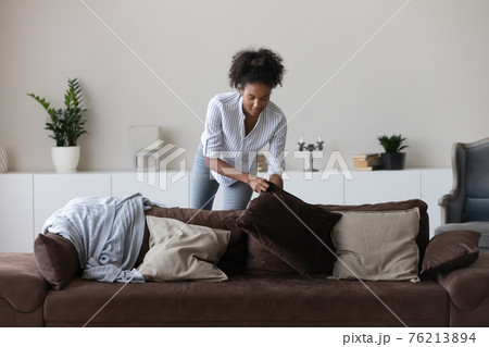 African American woman decorate cozy living room African American woman decorate cozy living room 76213894