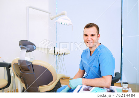 Dentist smiling man sitting in the office 76214484