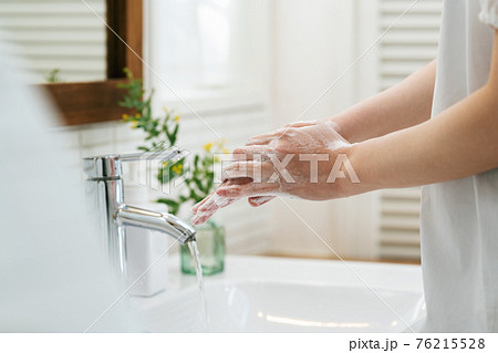 洗面所で手を洗う女性 76215528