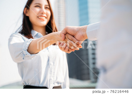 Businesswoman shaking hands with man Businesswoman shaking hands with man 76216446