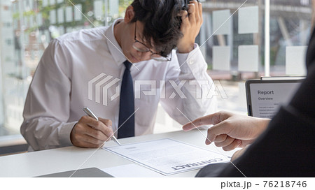 Man is signing a contract with the company, Supervisor orders the employee to sign the resignation document, End of the employment contract or termination of employment.  76218746