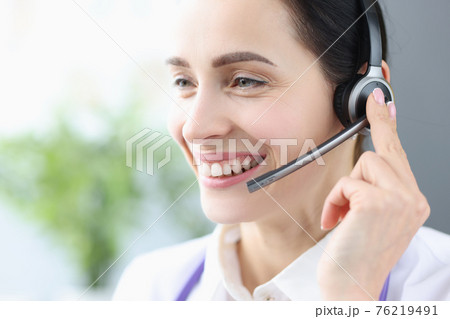Portrait of smiling woman with headphones and microphone 76219491