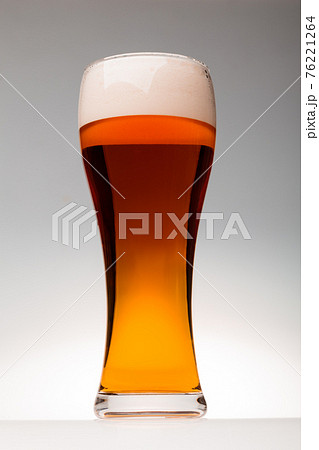 Tall glass of pilsner beer with head 76221264