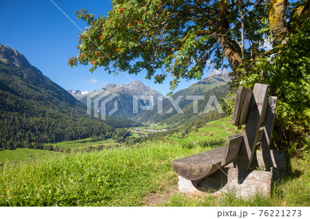 Bench overlooking Engadin Valley in Swiss Alps 76221273
