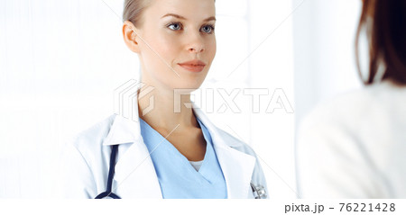 Woman - doctor consults her female patient in clinic. Medicine concept Woman - doctor consults her female patient in clinic. Medicine concept 76221428
