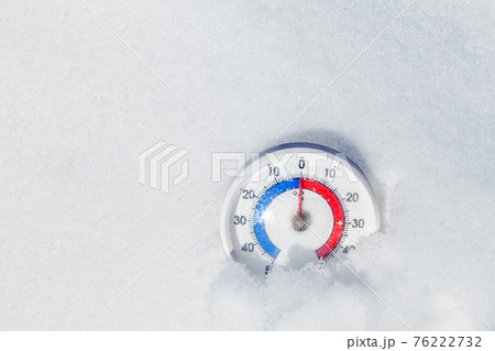 Outdoor thermometer in snow shows zero temperature spring weather concept Outdoor thermometer in snow shows zero temperature spring weather concept 76222732
