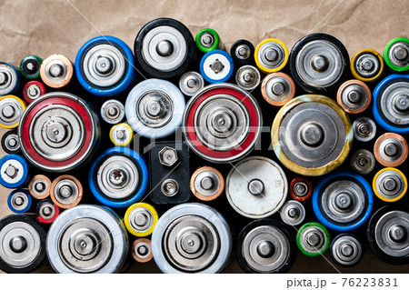 Used Alkaline batteries on recycled paper toxic waste recycling and ecology issues concept background Used Alkaline batteries on recycled paper toxic waste recycling and ecology issues concept background 76223831