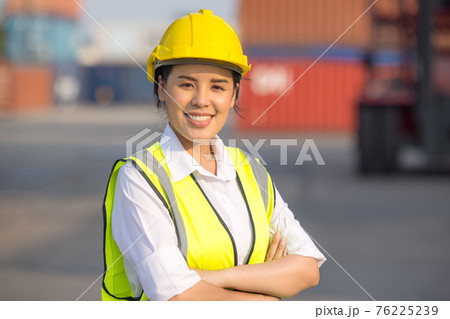 Portrait of logistic engineer worker woman foreman in hardhat and safety at containers cargo 76225239