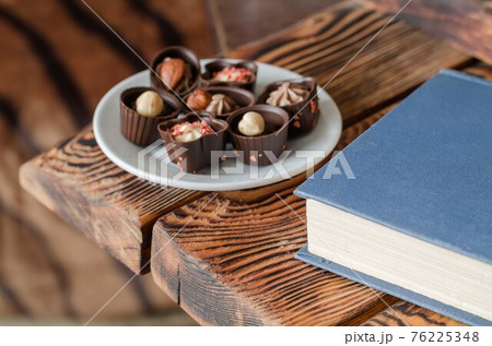 Group Chocolate candy on a white saucer. 76225348