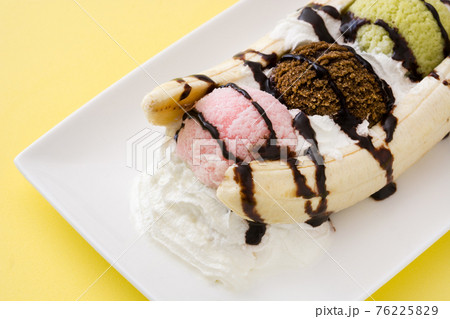 Banana split ice cream dessert with chocolate syrup isolated 76225829